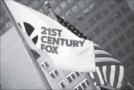  ??  ?? The flag of the Twenty-First Century Fox Inc. is seen waving at the company headquarte­rs in the Manhattan borough in New York June 11, 2015.