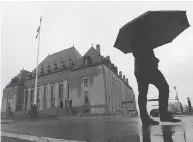  ?? SEAN KILPATRICK / THE CANADIAN PRESS FILES ?? A man walks pass the Supreme Court of Canada, which took up the case known as “free the beer.”