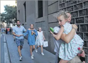  ?? AP PHOTO ?? People flee the scene in Barcelona, Spain, Thursday after a white van jumped the sidewalk in the historic Las Ramblas district, crashing into a summer crowd of residents and tourists. Police say 13 people were killed and more than 50 injured.