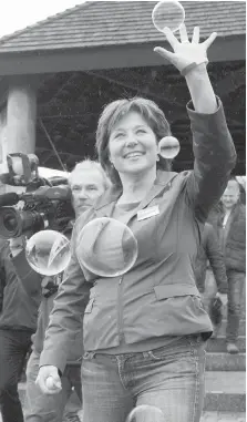  ?? JONATHAN HAYWARD, THE CANADIAN PRESS ?? B.C. Liberal Leader Christy Clark catches bubbles in Comox on Monday. Clark says the Island has a successful economic record because of Liberal policies.