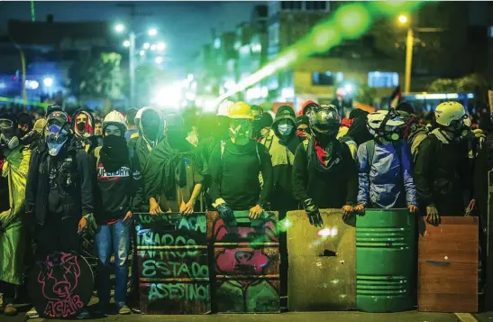  ?? AP ?? Manifestan­tes se preparan para una nueva marcha contra el Gobierno en la noche del miércoles en Bogotá