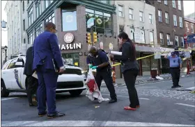  ?? ?? Philadelph­ia Police Investigat­ors work the scene of a fatal overnight shooting on South Street in Philadelph­ia, Sunday, June 5, 2022. (AP Photo/Michael Perez)