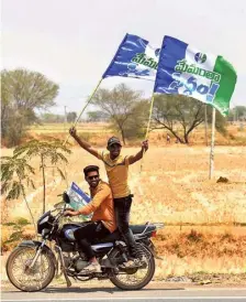  ?? ANI ?? Catchy phrase: Supporters hold flags with ‘Memantha Siddham’ slogans as they take part in Chief Minister Y.S. Jagan Mohan Reddy’s bus yatra.