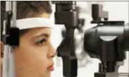  ?? BILL WEST—THE ASSOCIATED PRESS ?? In this Oct. 4, 2017, file photo, Dr. Albert Maguire, right, checks the eyes of Misa Kaabali, 8, at the Children’s Hospital of Philadelph­ia. Misa was 4-years-old when he received his gene therapy treatment. The first-of-its kind genetic treatment for...