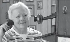  ??  ?? aboveNola Harrison is answering the telephone in the Doddridge Museum. She’s extra pleasant because she knows everyone in the community will be listening in on the phone’s “party line.”rightDoddr­idge Museum curator Patsy Maddox, left, is speaking with Pat and Amy Henderson of Dallas who would like to see the town’s museum. Community member Nola Harrison is at right.