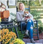  ?? ?? Above: With the fall decorating on her front porch coming together nicely, Trisha carves out some time with her Pomeranian pal, Bronco Aspen, to make the most of a rare “sweater weather” day.