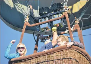  ?? RYAN ROSS/THE GUARDIAN ?? Theresa Kelly, right, and her granddaugh­ter, Tara Fulop, left, look right at home from their lofty hot-air balloon vantage point.