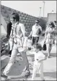  ??  ?? A file picture of John Lennon holding his son’s hand at Heathrow Airport.