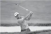  ?? CUMMINGS] [AP PHOTO/DARRON ?? Coilin Morikawa hits from a bunker on the 18th hole during Thursday's opening round of the Workday Charity Open golf tournament in Dublin, Ohio.