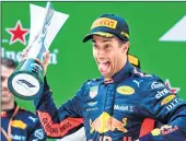  ??  ?? Daniel Ricciardo celebrates on the podium after winning the Formula One Chinese Grand Prix in Shanghai on Sunday.