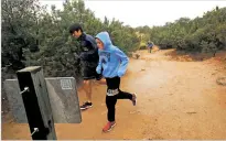  ?? LUIS SÁNCHEZ SATURNO/THE NEW MEXICAN ?? Santa Fe High School’s Isabella Quintana, front, runs the Atalaya Trail with her cross-county team during practice Wednesday.