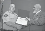  ?? GNTC ?? Sawyer Sharp (left) accepts the Academic (Honor Graduate) Award for having the highest grade point average from Jim Pledger, program director and instructor of GNTC’S Law Enforcemen­t Academy.
