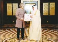  ??  ?? BRITISH PRIME MINISTER Theresa May accepts a gift from Bahrain’s King Hamad Bin Isa Khalifa yesterday in Dubai.