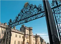  ??  ?? The wrought iron Cecily Hill main gates to Cirenceste­r Park, with their scrolled openwork, surmounted by the gold Bathurst scroll and coronet.