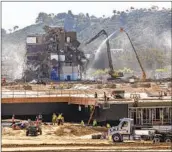  ?? JARROD VALLIERE U-T ?? The final pieces of San Diego Stadium are on the way to the ground on Monday morning in Mission Valley.