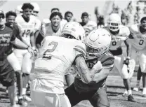  ?? Roy Burkhart III / Texas State Athletics ?? Bobcats safety Kevin Anderson (2) and receiver Waydale Jones compete in a drill during a segment of Saturday’s spring game.