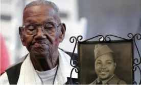  ?? Photograph: Gerald Herbert/AP ?? Lawrence Brooks holds a photo of himself taken in 1943.