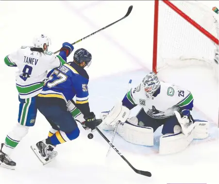  ?? JEFF VINNICK/GETTY IMAGES ?? Canucks goalie Jacob Markstrom robs Blues shooter David Perron during Game 5 on Wednesday night as Vancouver scored a 4-3 win over St. Louis to take a 3-2 series lead.