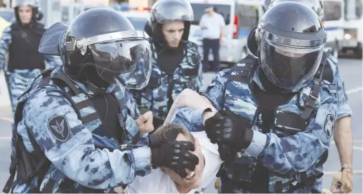  ?? (Shamil Zhumatov) ?? LAW ENFORCEMEN­T OFFICERS detain a protester at a Moscow rally calling for opposition candidates to be registered for elections.