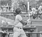  ?? MILWAUKEE MILKMEN ?? Milwaukee Milkmen outfielder Adam Walker wears a mask with a cow pattern while batting.