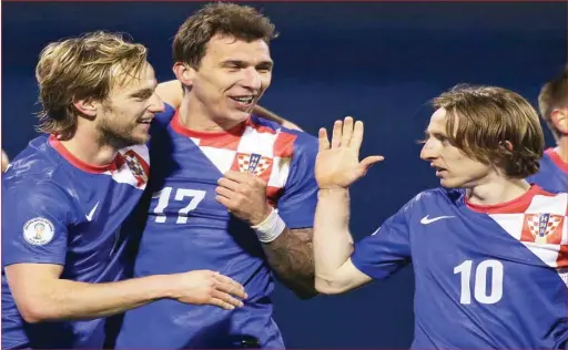  ??  ?? L-R Croatian stars Rakitic, Manduzkic and Modric celebratri­ng a goal