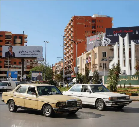  ?? Reuters ?? Electoral billboards dominate a junction in Tripoli, northern Lebanon. The Sunni-majority city has a turbulent past