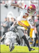  ?? The Associated Press ?? David Zalubowski
Southern California wide receiver Brenden Rice leaps over Colorado cornerback Omarion Cooper in the Trojans’ 48-41 victory on Saturday.