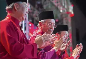  ?? — AP ?? All set: (From left) Muhyiddin, Dr Mahathir and Mukhriz clapping during the launch of PPBM in Shah Alam.