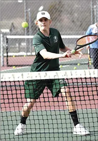  ?? PHOTO BY VICKY SHEA ?? Standout sophomore tennis player Calvin Hibbard eyes a volley at the net in SYML action against South. Hibbard won his singles match in dominating fashion, 6-0, 6-0.