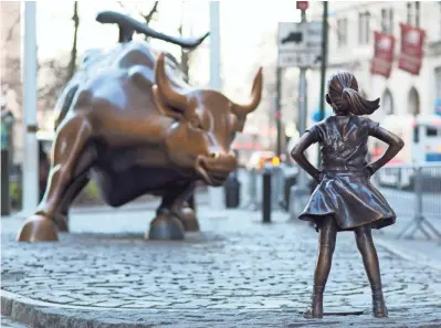  ?? MARK LENNIHAN, AP ?? Fearless Girl staked her claim in front of Charging Bull on the eve of Internatio­nal Women’s Day last month.