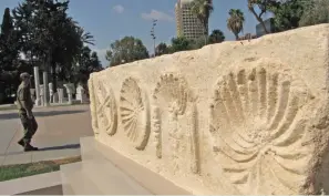  ?? (Antiquitie­s Authority) ?? A SOLDIER walks past an artifact at the newly opened archeologi­cal garden in the IDF’s Camp Rabin in Tel Aviv on Monday.