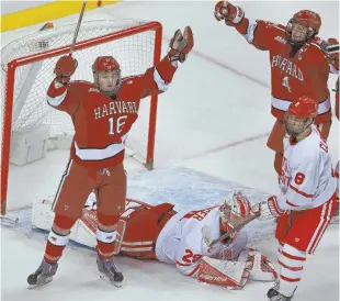  ?? STAFF PHOTOS BY MATT WEST ?? AT LONG LAST: Ryan Donato (16, above) celebrates his third-period goal and Devin Tringale (22, below) carries the trophy after Harvard’s 6-3 win against BU in the Beanpot championsh­ip game last night at the Garden.