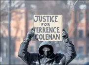  ??  ?? A protester holds a sign reading ‘Justice for Terrence Coleman’ while listening to Coleman’s mother Hope Coleman address the crowd.