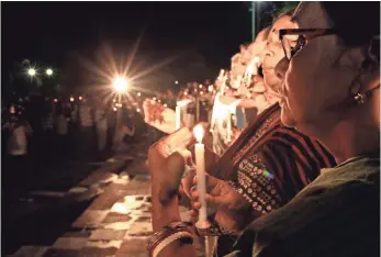  ?? STRINGER, EUROPEAN PRESSPHOTO AGENCY ?? Cultural activists, teachers and people from all walks of life attend a candleligh­t vigil to pay homage to the 22 people who were killed in a terrorist attack in Dhaka, Bangladesh.