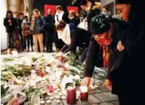  ?? Reuters ?? People cry as they light candles in tribute to the victims of the deadly shooting in Strasbourg, France, on Thursday.