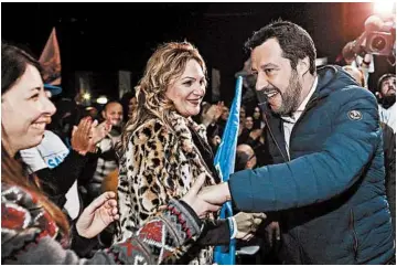  ?? RICCARDO ANTIMIANI/ANSA ?? The League party’s candidate for premier, Matteo Salvini, shakes hands with sympathize­rs at an electoral meeting.