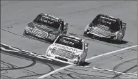  ??  ?? GETTY IMAGES
Kyle Busch leads Ryan Blaney (left) and Erik Jones to the checkered flag Saturday in the NASCAR Camping World Truck Series.