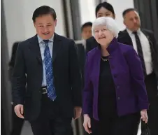  ?? — AFP photo ?? Yellen walks with People’s Bank of China Governor Pan Gongsheng during her visit to the central bank headquarte­rs in Beijing.