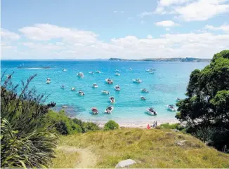  ?? Photos / Brett Phibbs, Jim Eagles, Getty Images, NZME, Supplied ?? A photograph­er on North Head at sunrise, top left; kayaking the Te Ara Moana sea trail, top; Hobbs Bay on Tiritiri Matangi, above; a kotare on Tiritiri Matangi, left; a takahe on Rotoroa Island, below.