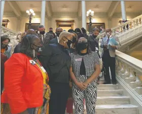  ?? (AP/Jeff Amy) ?? Georgia House Democrats speak with Democratic Rep. Park Cannon (right) in Atlanta during a sitin at the state capitol sparked by opposition to Republican proposals that would restrict voting. On Friday, The Associated Press reported on a video circulatin­g online incorrectl­y asserting left-wing protesters stormed Georgia’s Capitol building in Atlanta or engaged in an insurrecti­on over a bill that would require photo ID for absentee voting. However, the Georgia Department of Public Safety confirmed the protesters entered the state Capitol lawfully and remained peaceful, unlike the rioters in the violent Jan. 6 insurrecti­on in Washington.