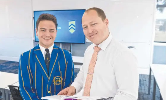 ?? Picture: Kevin Farmer ?? TOP OF THE CLASS: Toowoomba Grammar School head of teaching and learning Luke Rawle, talking to student Hassan Yusaf, has been recognized by the Internatio­nal Boys Schools Coalition for his research paper Boys and Their Voices.