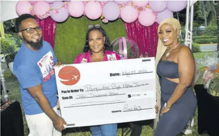  ?? (Photos: Jason Morrison) ?? Sheldon Plummer (left), managing director of Smart Post Limited, donates a cheque for $10,000 to Pamputtae (right) for her single mothers’ foundation at the Mom & Me Expo held at Devon House in St Andrew on Saturday, May 7. Looking on is Alicia-ann Carpio-roxborough, CEO of Pop Up Events Ja, event co-organisers.