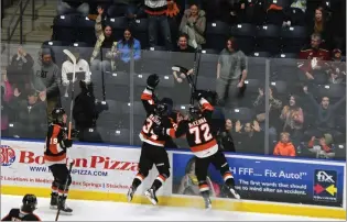  ?? NEWS PHOTO JAMES TUBB ?? Medicine Hat Tigers forwards Andrew Basha and Gavin McKenna celebrate a tying goal in the third period of a 5-4 overtime win over the Red Deer Rebels at Co-op Place on Feb. 10.