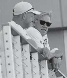  ?? David Zalubowski, The Associated Press ?? Broncos general manager John Elway, right, confers with Matt Russell, the team’s director of player personnel, during a combined practice with the San Francisco 49ers on Saturday at the Broncos’ headquarte­rs.