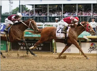  ?? MARK HUMPHREY — THE ASSOCIATED PRESS ?? Rich Strike (21), with Sonny Leon aboard, beats Epicenter (3), with Joel Rosario aboard, at the finish line to win the 148th running of the Kentucky Derby at Churchill Downs on Saturday in Louisville, Ky.