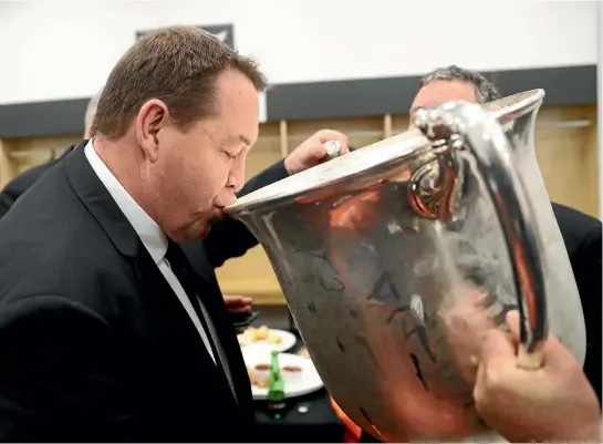  ?? PHOTO: GETTY IMAGES ?? Steve Hansen takes a drink from the vast Bledisloe Cup which remains firmly in the All Blacks’ hands after Saturday’s convincing win over New Zealand in Wellington.