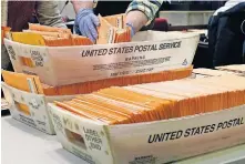  ?? ASSOCIATED PRESS] ?? Election officials sort absentee and early voting ballots for counting Monday inside Boston City Hall in Boston. [ELISE AMENDOLA/ THE