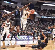  ?? Jessica Hill / Associated Press ?? UConn’s James Bouknight (2) is fouled by Memphis’ Alex Lomax (2) as he goes up for a basket on Feb. 16.