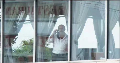  ?? WAYNE PARRY — THE ASSOCIATED PRESS ?? Bill Hrisafinis, owner of the Rainbow Diner in Brick, N.J., looks out the window of his diner toward the outdoor dining area on, Monday, Aug. 31, 2020.