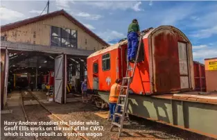  ??  ?? Harry Andrew steadies the ladder while Geoff Ellis works on the roof of the CW57, which is being rebuilt as a service wagon